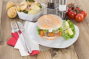 Fish Burger with fried Potatoes in a bowl