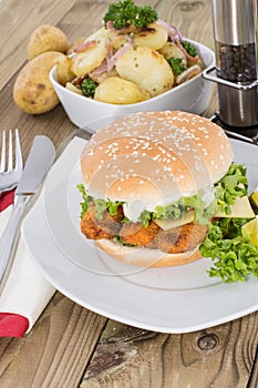Fish Burger with fried Potatoes in a bowl