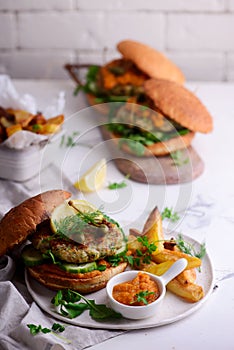 Fish burger with herb and corgette sauce