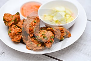 Fish cakes on white plate , fried fish paste balls with sauce - Asian Thai food