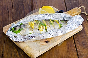 Fish carcass Dicentrarchus labrax with lemon, baked in foil with spices.