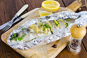 Fish carcass Dicentrarchus labrax with lemon, baked in foil with spices.