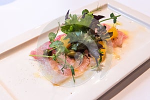 Fish Carpaccio of yellowtail with salad