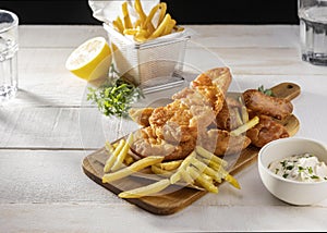fish chips chopping board with lemon sauce. High quality photo