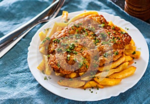 Fish and Chips. Fried fish fillet and potatoes in a white plate