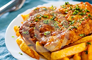 Fish and Chips. Fried fish fillet and potatoes in a white plate