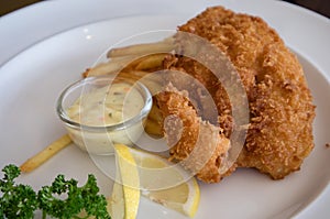 Fish and chips on white plate