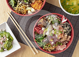 Fish chirashi, japonese food on bowls with wooden hashis