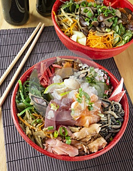 Fish chirashi, japonese food on bowls with wooden hashis photo
