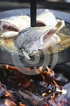 Fish cooking on open fire