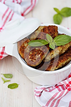 Fish cutlets countrylike in ceramic saucepan