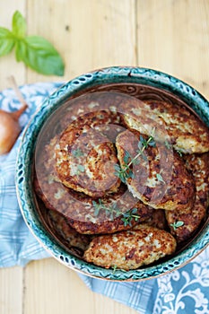 Fish cutlets countrylike in rustic plate, top view