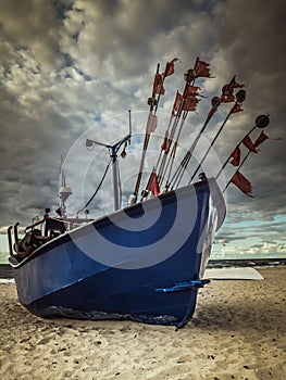 Fish cutter moored at the sandy beach