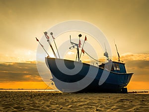 Fish cutter moored at the sandy beach