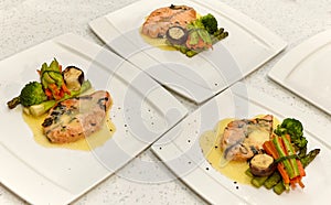 Fish dish: fried or baked salmon with vegetables and sauce