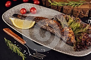 Fish dish - grilled herrings with cherry tomatoes