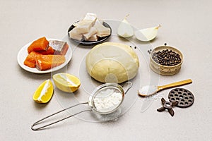 Fish dumplings. Ingredients for home cooking. Fresh dough, fish, spices, cooking equipment