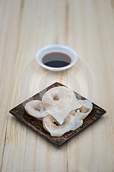 Fish dumplings in wooden dish on wood background.