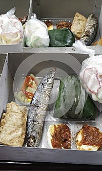 Fish, egg sambal in lunch box photo