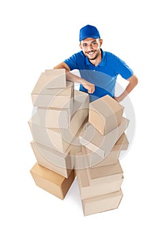 Fish eye shot of smiling courier with stack of cardboard boxes