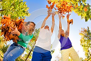 Fish-eye view of friends playing with leaves