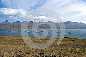 Fish farm in Berufjordur fjord in eastern Iceland from Ring Road on sunny day. photo