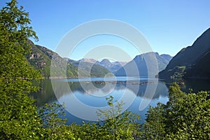 Fish farm in Hardangerfjord, in a beautiful fjord environment, with reflections of the mountains, Rosendal, Norway