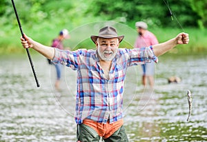 Fish farming pisciculture raising fish commercially. Pensioner leisure. Fish on hook. Man senior fisherman. Fisherman photo