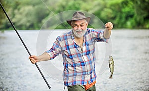 Fish farming pisciculture raising fish commercially. Pensioner leisure. Fisherman alone stand in river water. Hobby