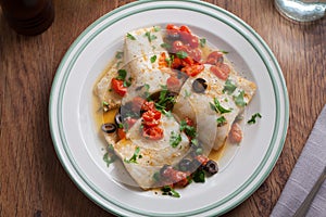 Fish fillet with cherry tomatoes and olives