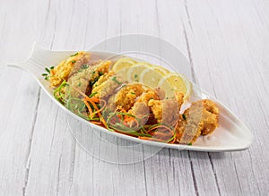 Fish Fillet with lime served in dish isolated on grey wooden background side view of fastfood