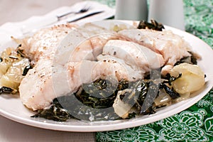 Fish fillet pieces on a green cabbage