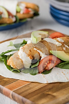 Fish finger wraps with avocado and tomato