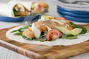 Fish finger wraps with avocado and tomato