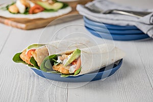 Fish finger wraps with avocado and tomato