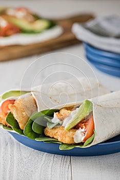 Fish finger wraps with avocado and tomato