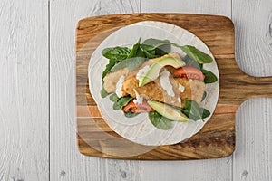 Fish finger wraps with avocado and tomato