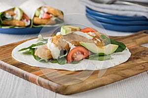 Fish finger wraps with avocado and tomato