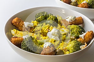 Fish fingers with yellow rice and broccoli - hearty rustic recipe with selective focus