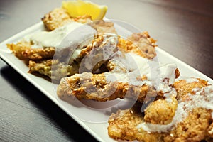 Fish fried in batter,Delicious battered fish on a plate with chips,Fish and chips meal.