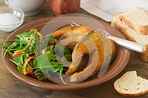 Fish fried in corn flour, served with salad, bread and wine.