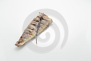 Fish fried on the grill and served on a plate with fresh vegetables photo