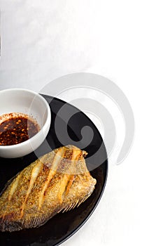 Fish fry on black plate ,Trichogaster pectoralis, fish salid.