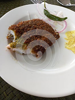 Fish fry served hot on a white plate.