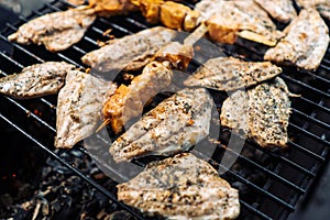 The fish is grilled, burning coals.