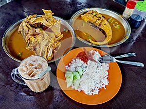 Fish head curry, stingray curry, teh tarik and rice meal, Kuala Lumpur.