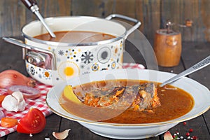 Fish head soup with vegetables in the pot.