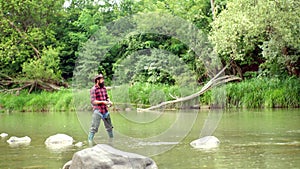 Fish on the hook. Man with fishing rods on river berth. Angler. Fly fishing is most renowned as a method for catching