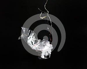 Fish hook with marine litter. plastic bag. pollution concept