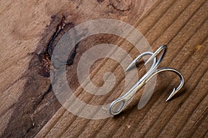 Fish Hook on a wooden background photo